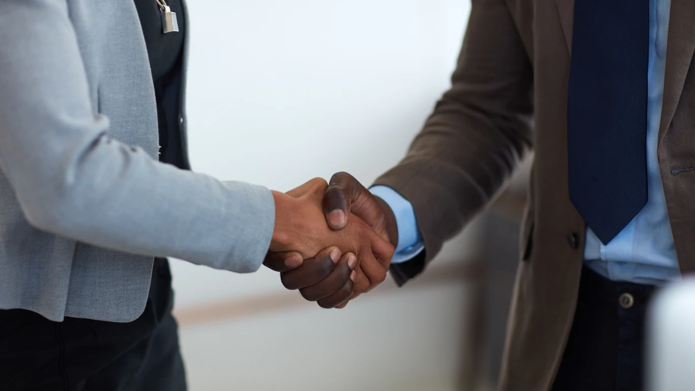 Two individuals shaking hands