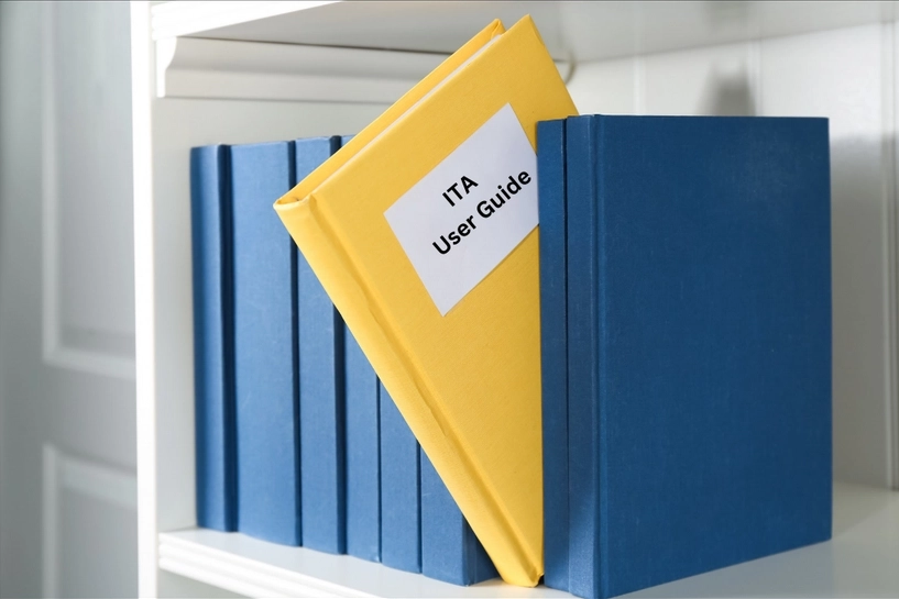 Binder labeled "ITA User Guide" in a shelf
