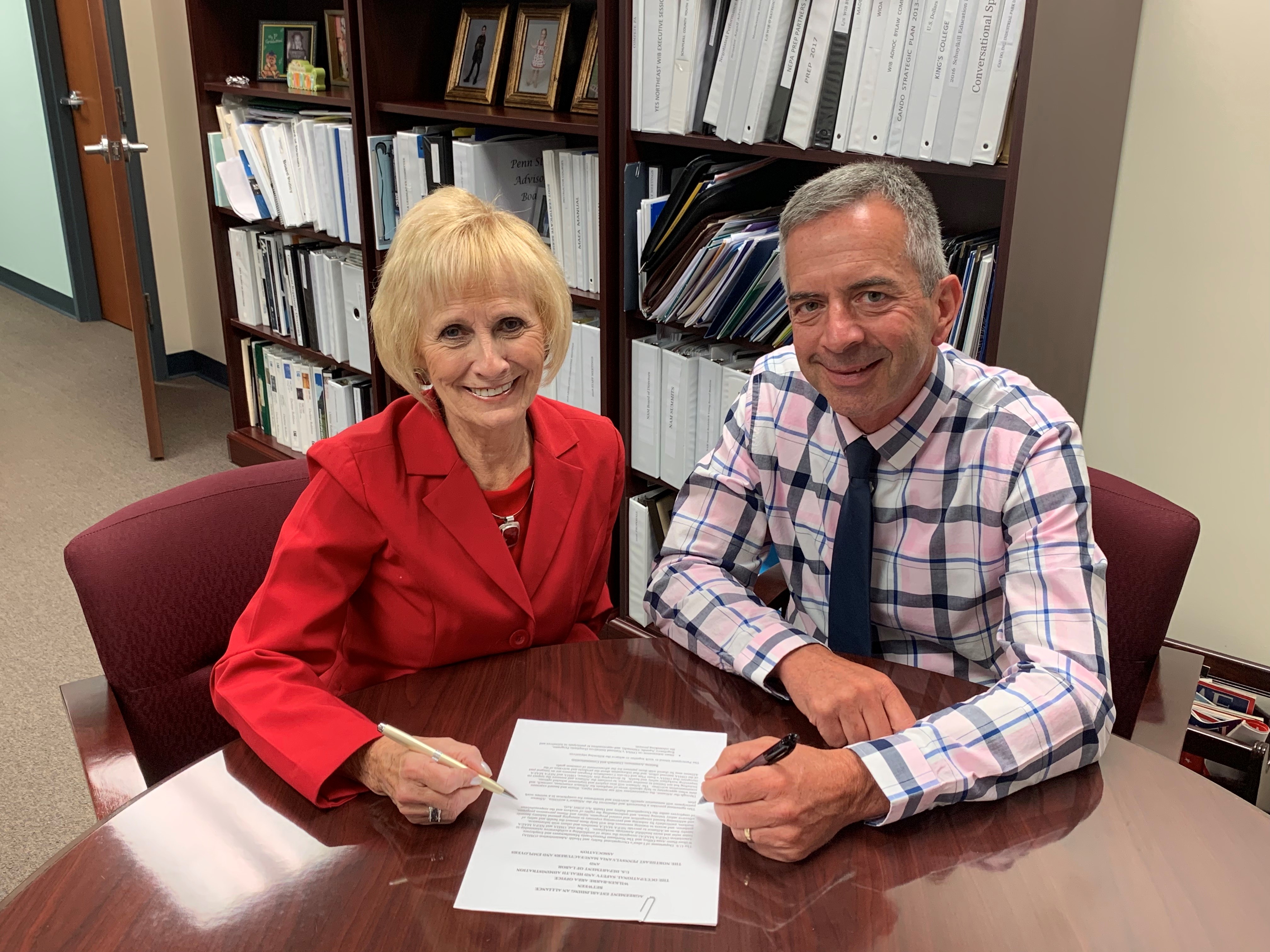 Mark Stelmack, Area Director, DOL-OSHA Wilkes-Barre Area Office and Darlene Robbins, President, NPMEA sign the alliance agreement on August 15, 2019.