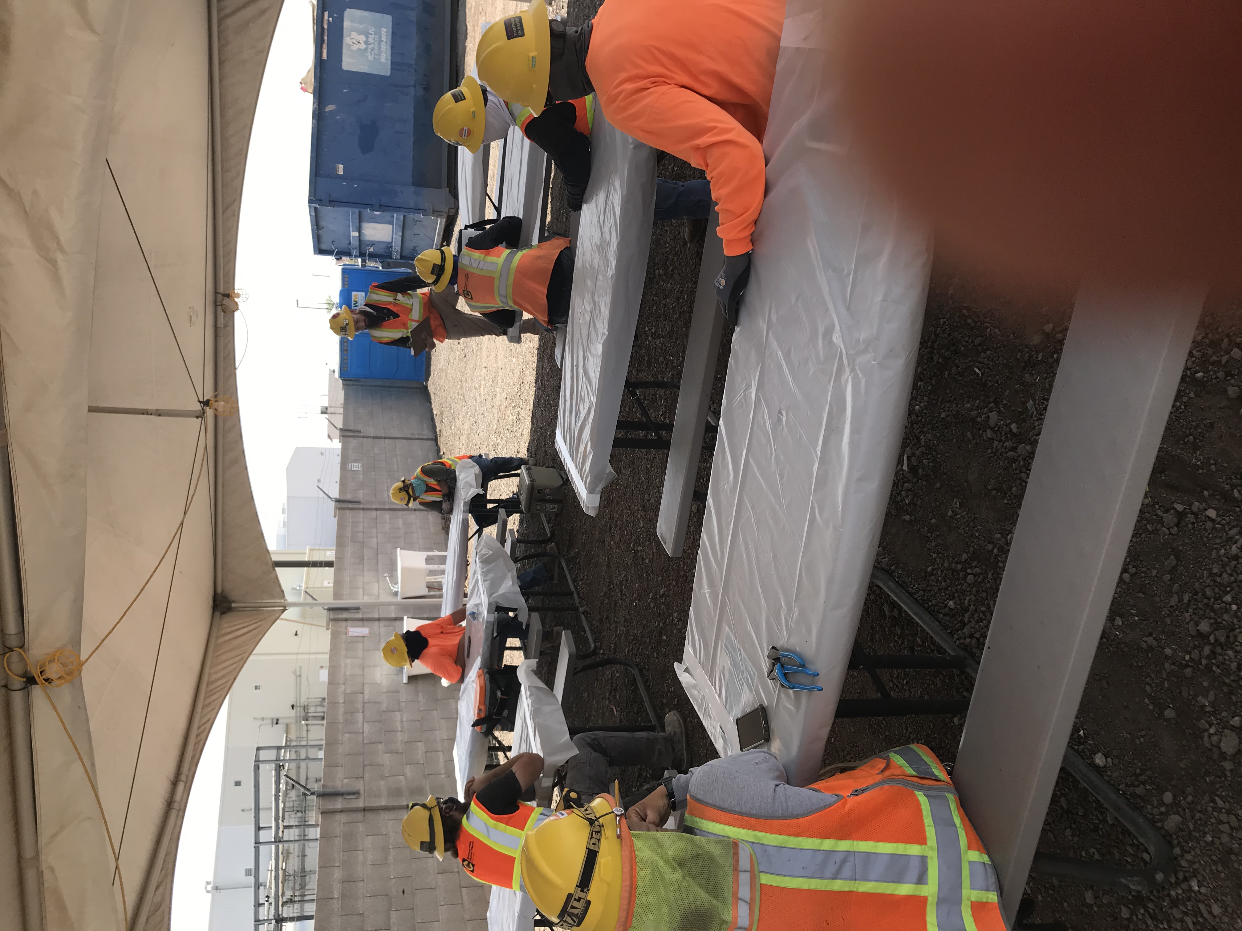 Photo of International Brotherhood of Electrical Workers (IBEW) conducting a safety meeting. Each wearing face masks and sitting six feet apart for social distancing during the Coronavirus Pandemic