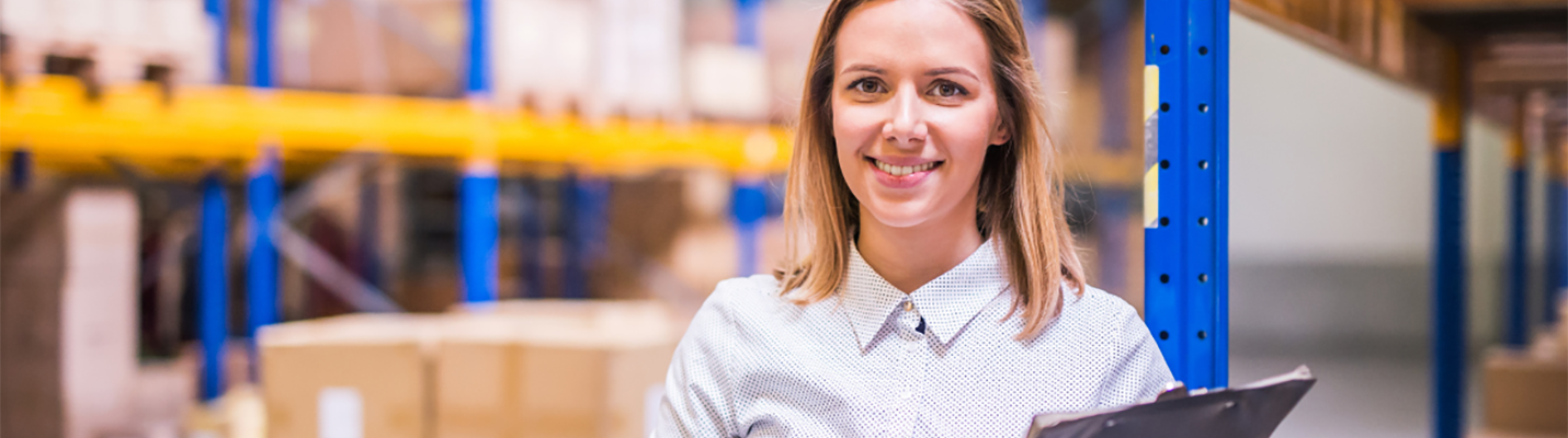 Law and Regs : employee in warehouse holding clip board