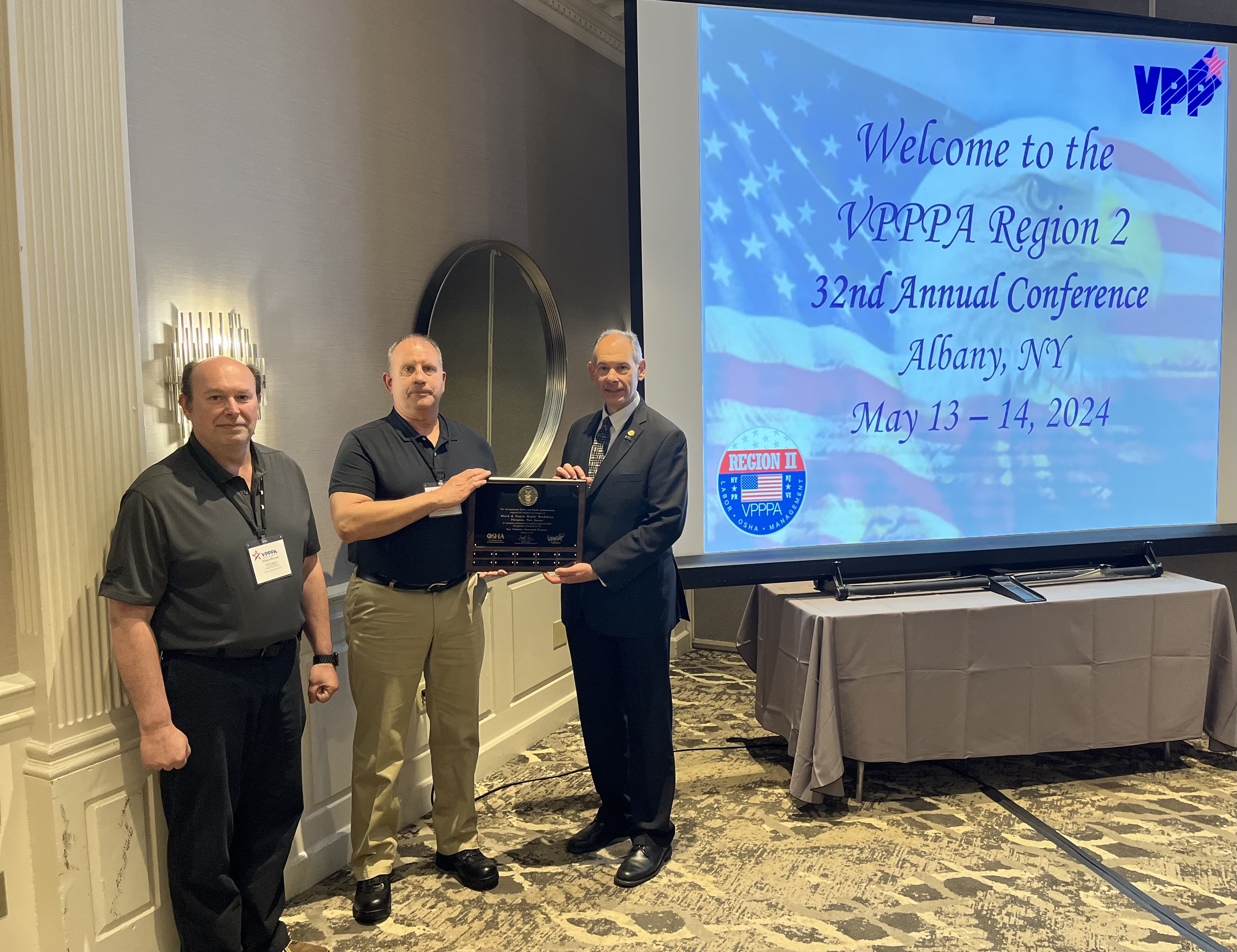 Richard Mendelson, OSHA Regional Administrator, presents the VPP Star Mobile Workforce plaque to Robert Brynes, Region II VPPPA Board Chairperson and Edward Williams, Black & Veatch, ESH Manager on May 13, 2024.