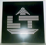 Solid metal panel with slots cut out in some places to form a logo