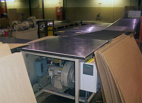 Air table used to transfer the bundles from the stacker outfeed conveyor to the load former