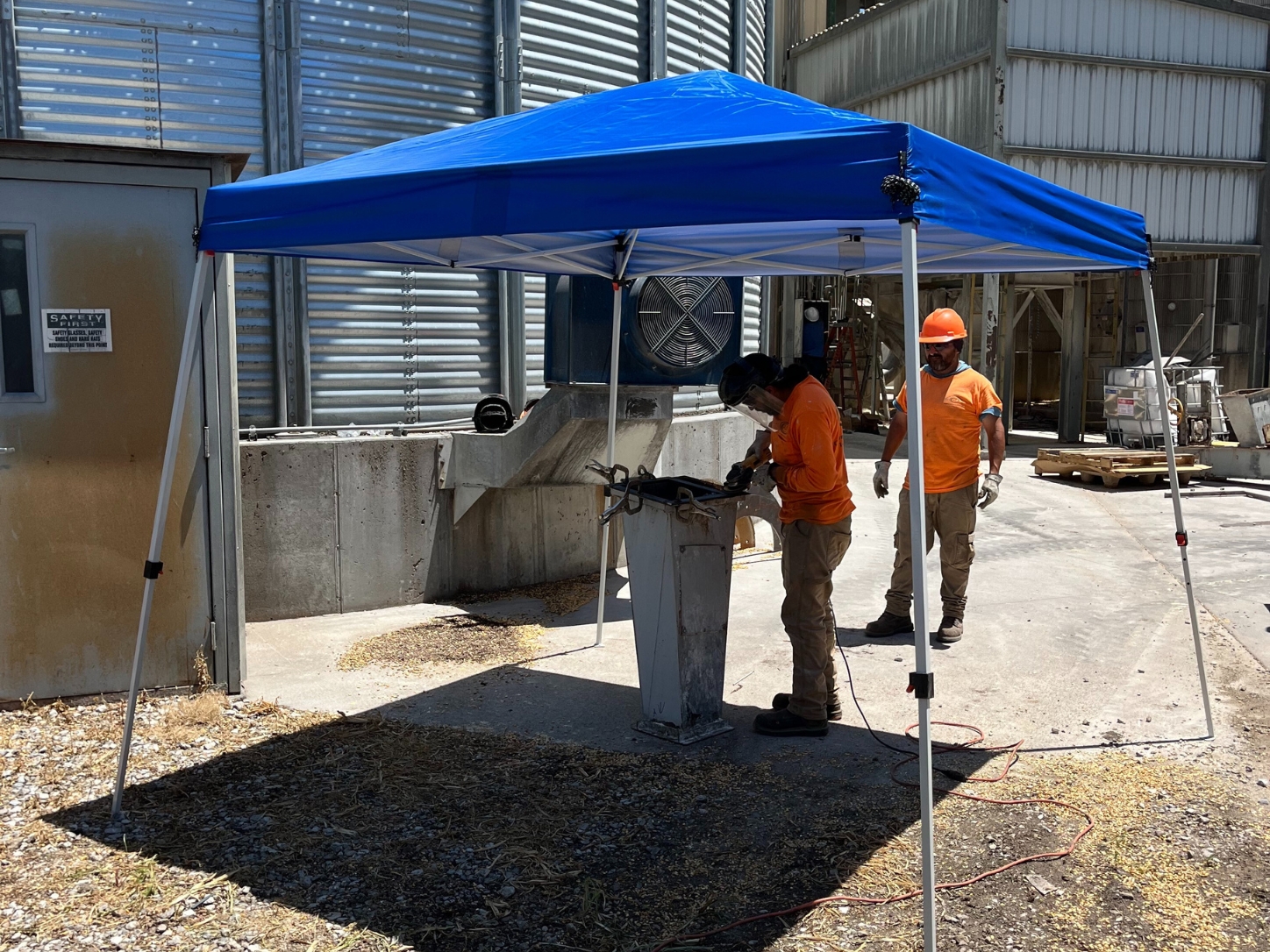 Custom Agri Systems, Inc. : outdoor work areas may not have a covered or permanent shade structure