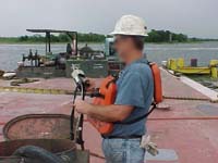 Figure 8: Shipyard Competent Person (SCP) checking atmosphere prior to entry.