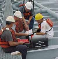 Figure 7: Workers reviewing MSDS information before work begins.