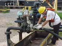 Figure 18: Worker hooking up suction hose.