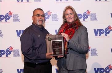 Then-Acting Director, Directorate of Cooperative and State Programs, Kimberly A. Locey, presenting SGE award to Gilbert Aceves.