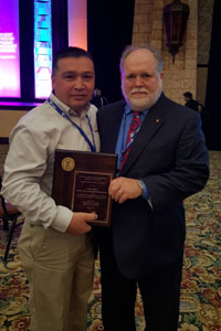 Former-Office of Partnerships and Recognition Director, David Hamel, with winner, Mark Moya, Honeywell Technology Solutions, Inc., Colorado Springs, CO.