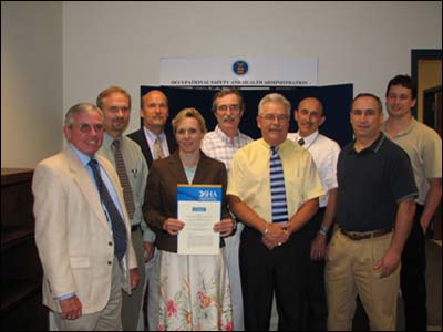 Cobb Hill Construction and Pro Con Construction Joint Venture, LLC OSP Signing (June 2006). Picture (from left to right): Kevin Clarke, OSHA Region I; Gerry Kingwill, Principle of Cobb Hill;Tom Avelone, President of Cobb Hill; Rose Ohar, Area Director of Concord NH Area Office; Steve Beyer, Director of NH, OSHA Consultation Program; Richard Lambert, Manager of ProCon Construction; George Kilens, AAD Concord NH OSHA Office; David Berard, CAS Concord, NH OSHA Office; Steve Rook - AAD Concord NH OSHA Office