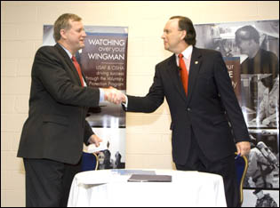 Edwin G. Foulke, Jr., former Assistant Secretary of Labor, OSHA (left) and William C. Anderson, Assistant Secretary of the Air Force, Installations,Environment and Logistics (right), shake hands after the signing of the national USAF OSP agreement on August 27, 2007.