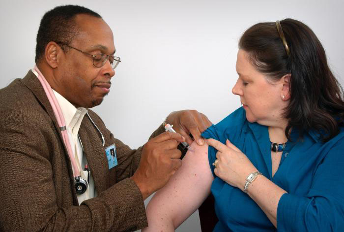 A Doctor giving a women a shot | Photo Credit: Centers for Disease Control and Prevention (CDC)/Judy Schmidt