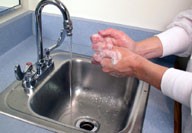 Image of washing hands over sink