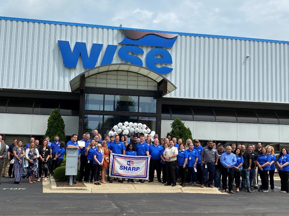 Employees standing with their SHARP flag.