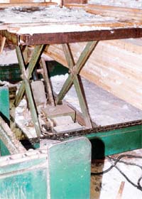 Elevated stacking table. Note the pinch points between the table and framework.