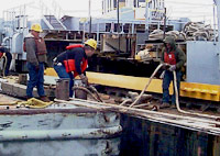 Figure 2: Workers protected with lifejackets (PFDs) while docking and boarding barge.