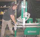 Employee using machine to bend conduit