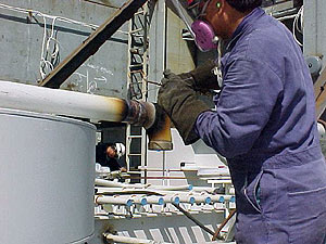 Figure 2: Worker brazing on a pipe