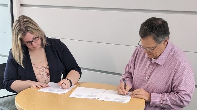 OSHA Denver Area Director Amanda Kupper and Aims Community College Executive Vice President Dr. Russ Rothamer signing the alliance