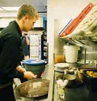 young worker cleaning up from serving