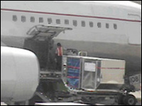 Figure 2. Baggage bins are mechanically lifted to loading platform