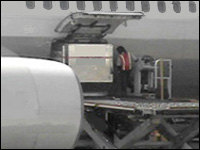 Figure 3. Bins are mechanically pulled across loading platforms and through the door.