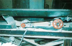 Vibrating conveyor and unguarded belt and pulley drive mechanism.