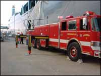 Figure 6. Fire truck on dock attempting to extinguish fire on vessel.