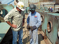 Figure 14: Worker inspecting broken insulation on power cable.