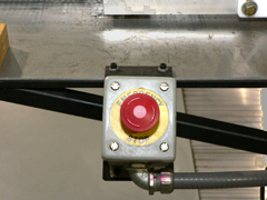 Close-up image of the red emergency stop button.