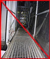 Figure 4: Improper practice - Fixed ladder extending out of an enclosed space with less than 4-inch clearance behind the ladder rung