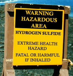 Figure 20. H2S warning sign: Warning Hazardous Area is in yellow letters on a black background and in black letters on a yellow background. The sign says H2S, Extreme Health Hazard, Fatal or Harmful if Inhaled. Reference API RP 49 - Photo Credit: iStockphoto