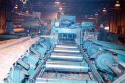 Infeed chain conveyors (left to right) to infeed roller conveyor to horizontal band saw