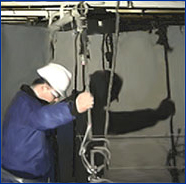 Image of a qualified person inspecting overhead support connections