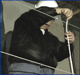 Photo courtesy of VSRA. Image shows a worker on staging with wire rope guardrails.