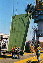 Figure 4: Riggers attaching slings to load with shackles and clamps