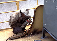 Figure 2: Worker grinding painted metal may be exposed to inhalation hazards