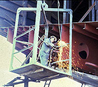 Figure 1: Worker using suspended scaffold (not fully guarded) for burning and without personal fall protection