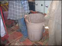 Figure 8. Workers removing trash from vessel space.