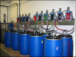 Figure 30. Ink dispensing system with pumps mounted on trays on the wall overhead.