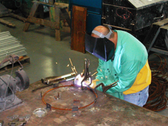 Figure 3 Using a jig allows employee to use both hands to control tool and maintain neutral hand position.