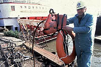 Figure 3: Worker holding PFD and life ring with attached rescue line