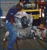 Figure 3. Employee lifting heavy equipment.