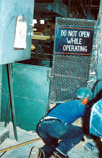 Worker cleaning electrical cabinet.