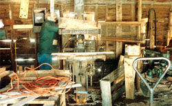 A worker risks injury by putting his hands in the saw that is shut down but not locked out.