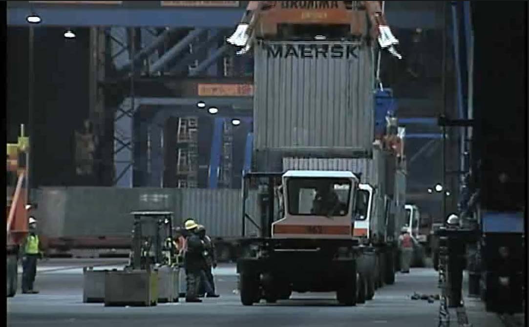 Workers operating a top-loader