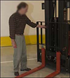 Figure 8. Operator inspecting the load backrest as part of the pre-operation inspection.