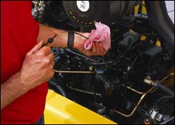 Figure 2. Operator checking fluid levels.