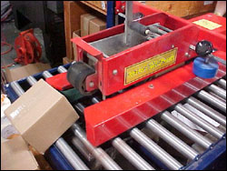 Figure 46. This machine automatically applies tape to the box, which reduces employee overexertion.